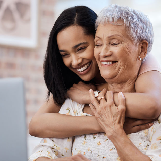 Woman with arms around woman